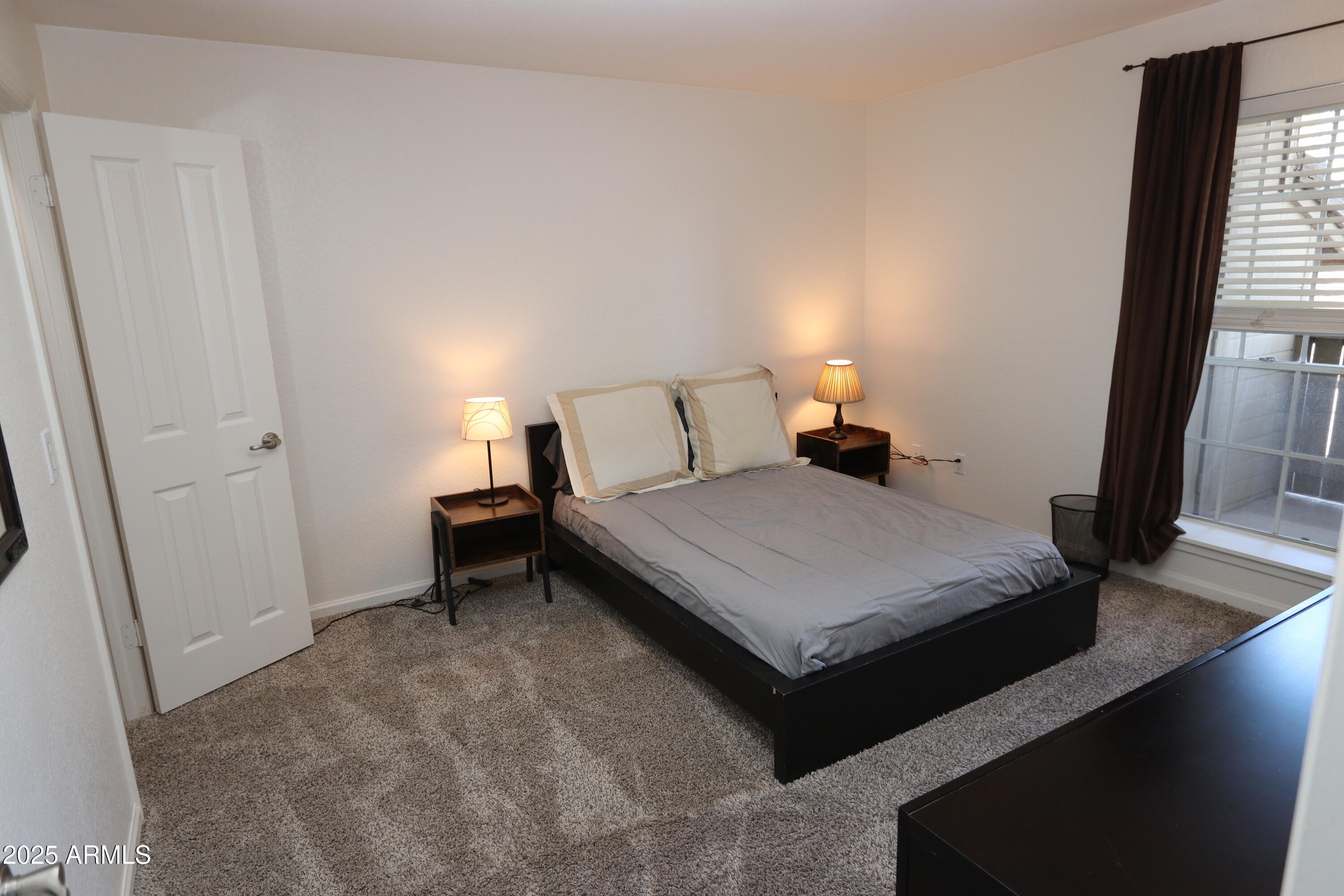 200 East Southern Avenue, Unit 307 Tempe, AZ 85282 - Photo 7 of 16 a bed room with a bed and a window