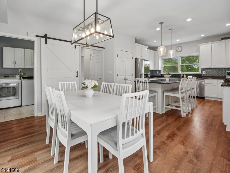 610 River Road Chatham, NJ 07928 - Photo 11 of 42 a view of a dining room with furniture wooden floor and chandelier