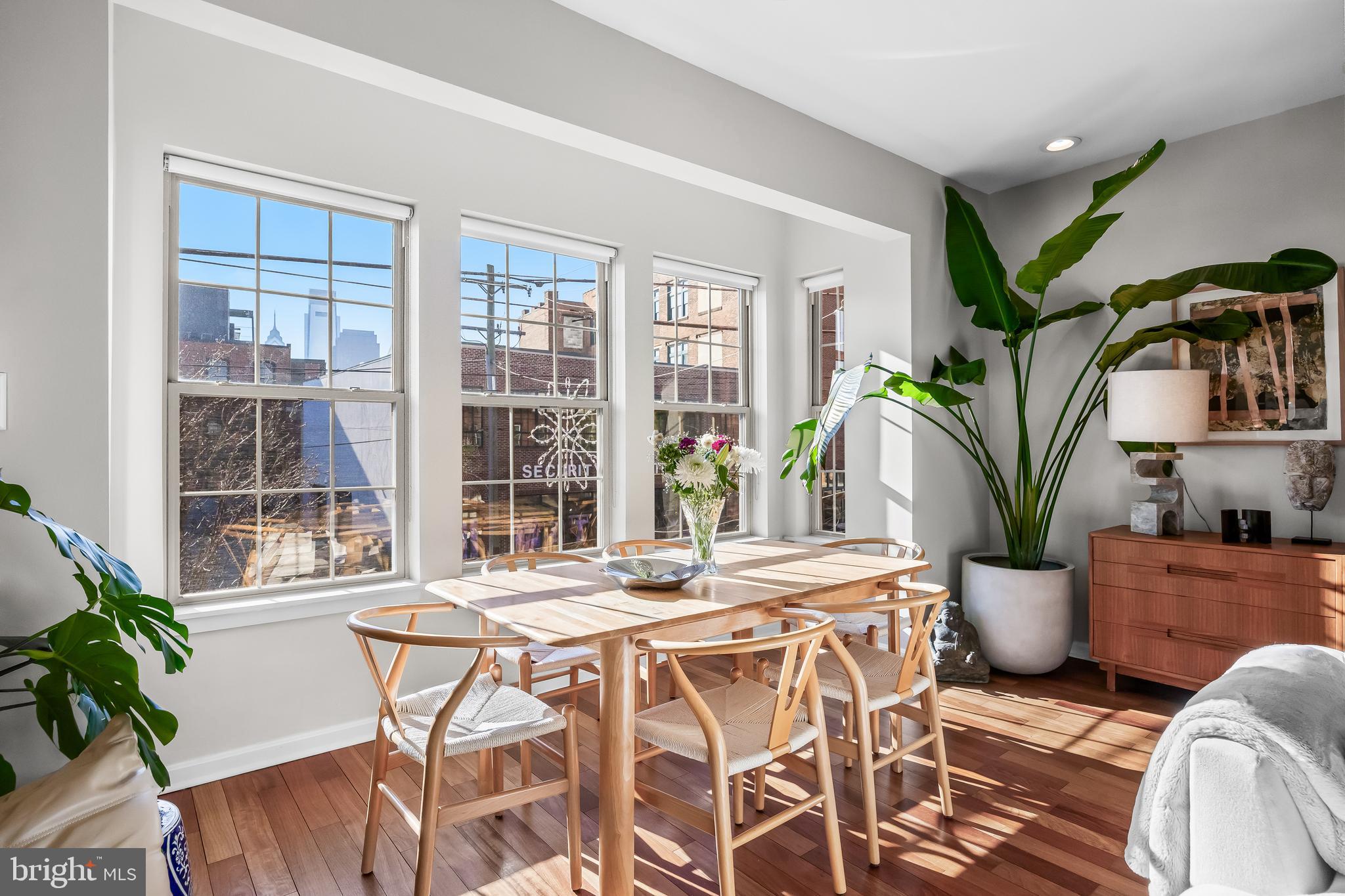 1627 Fairmount Avenue, Unit B Philadelphia, PA 19130 - Photo 13 of 46 a dining room with furniture potted plants and wooden floor