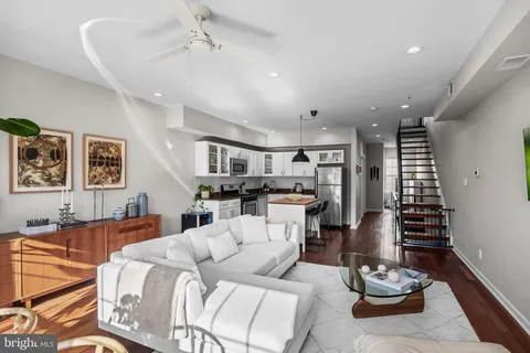 a living room with furniture kitchen and a window