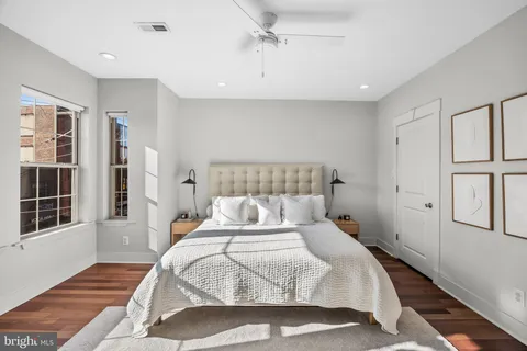 a bedroom with a bed and a large window