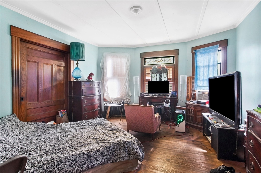 31 Chase Avenue Springfield, MA 01108 - Photo 6 of 29 a bedroom with a bed flat screen tv and dresser