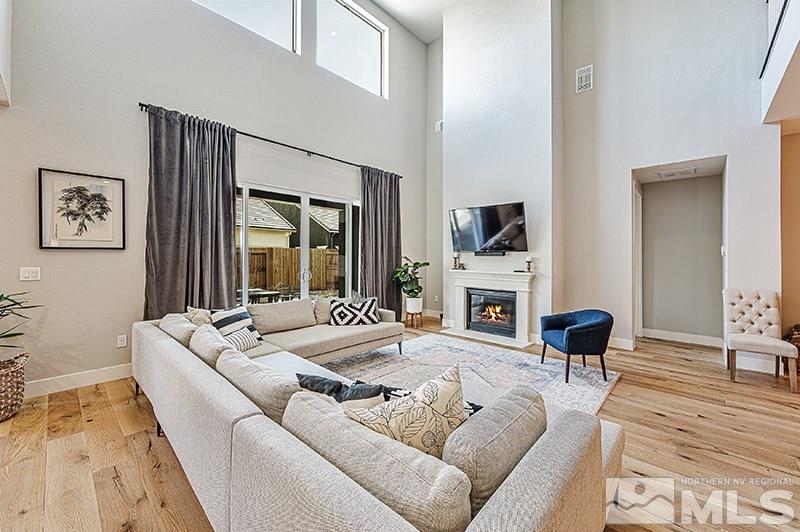 9460 Baldacci Road Reno, NV 89521 - Photo 3 of 25 a living room with furniture fireplace and a flat screen tv