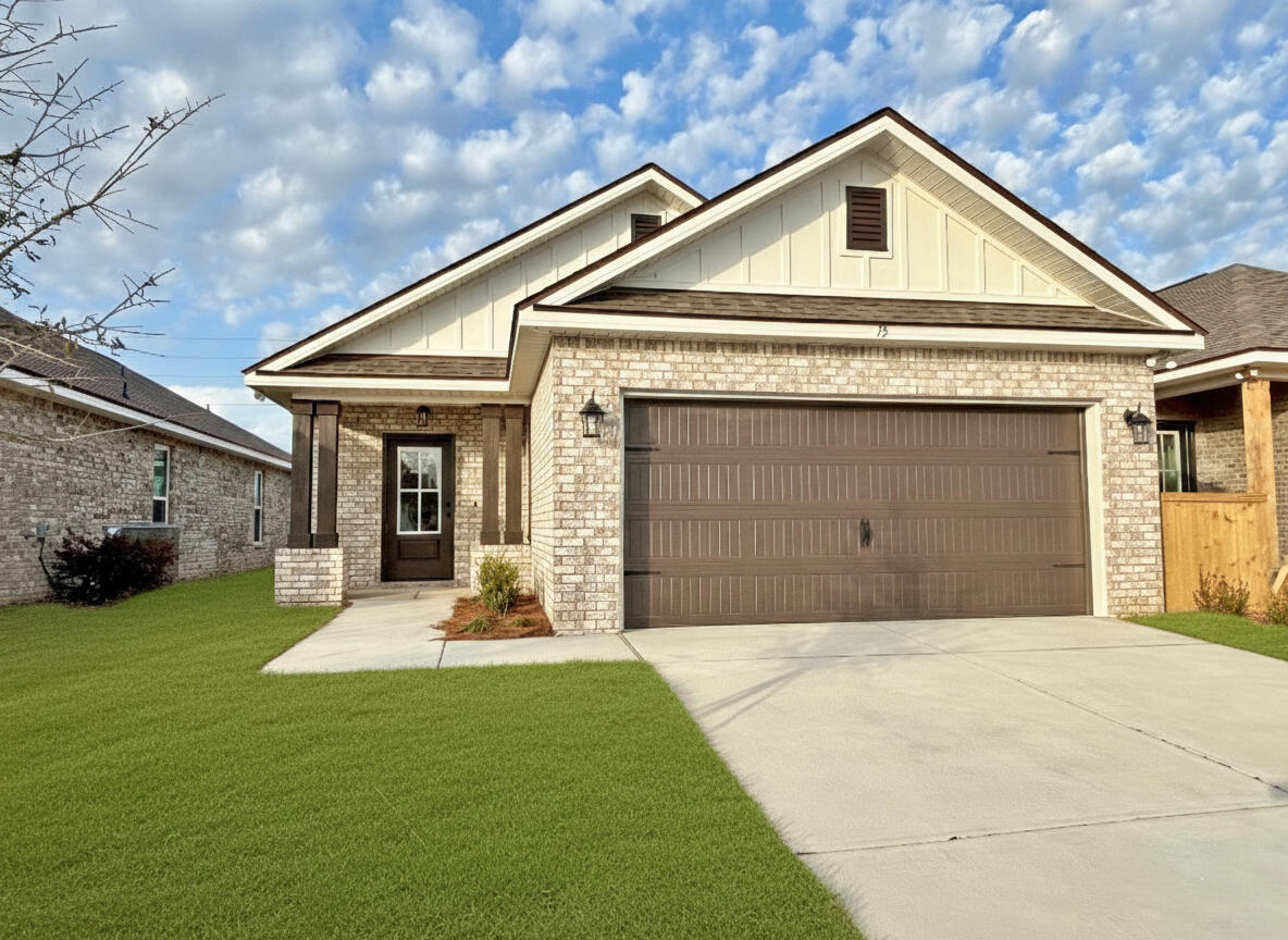 75 Natureview Way Ponce de Leon, FL 32455 - Photo 1 of 23 a front view of a house with a yard and garage