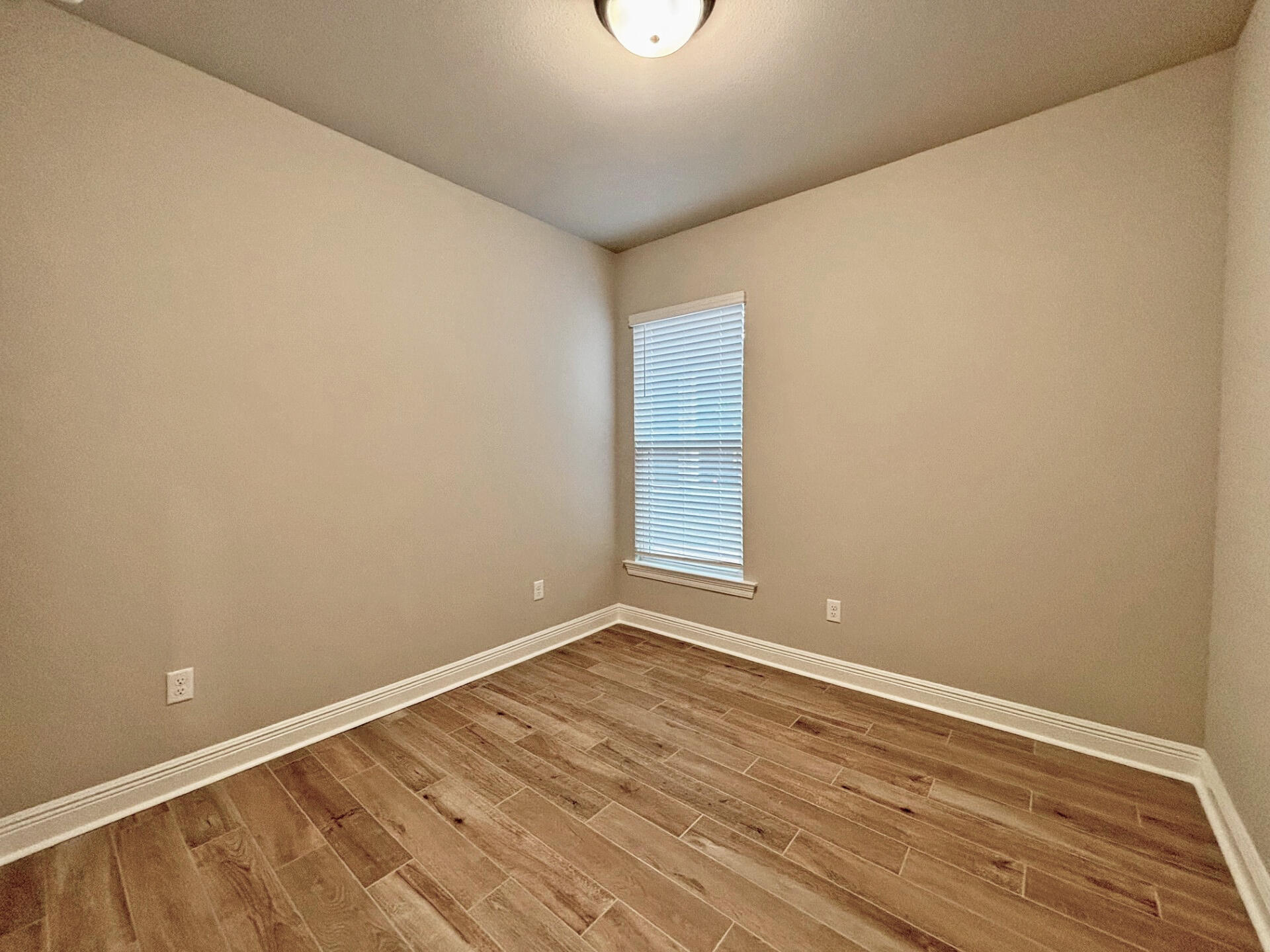 75 Natureview Way Ponce de Leon, FL 32455 - Photo 17 of 23 a view of an empty room with wooden floor and a window