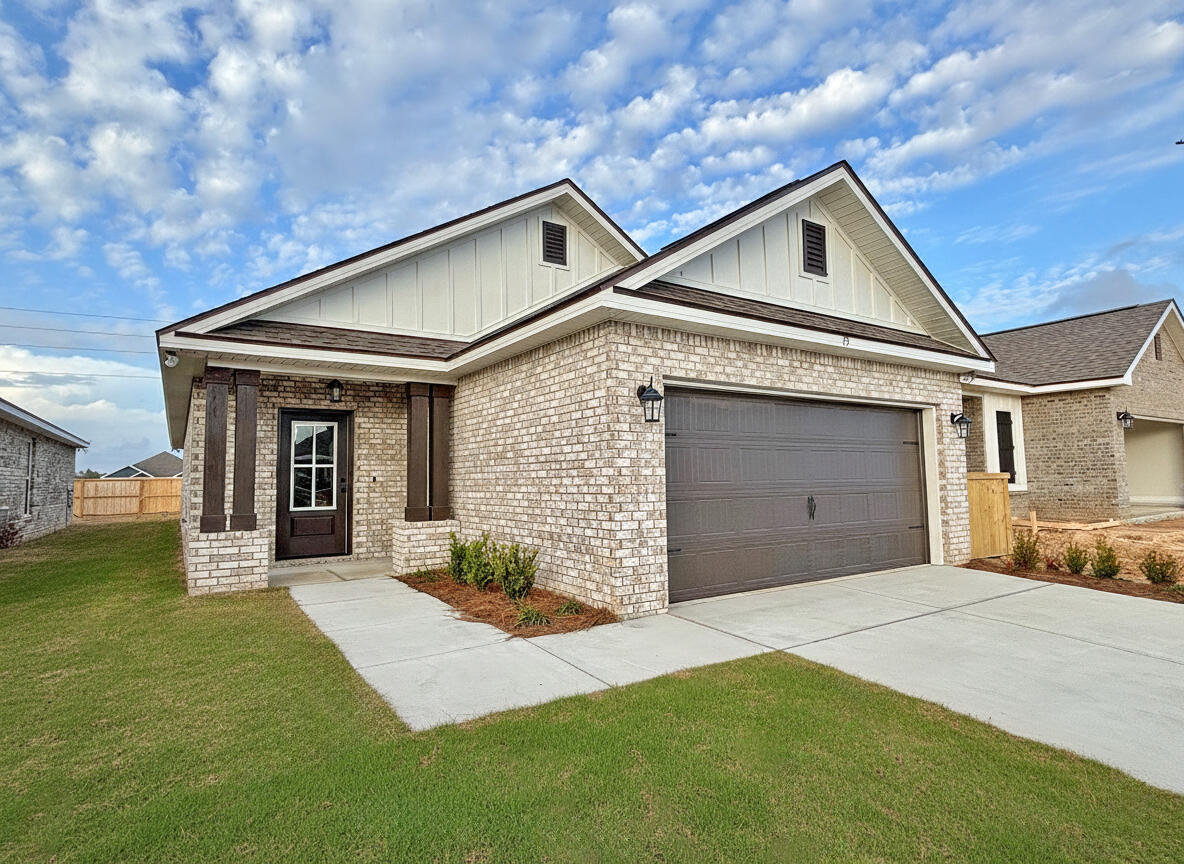 75 Natureview Way Ponce de Leon, FL 32455 - Photo 2 of 23 a front view of a house with a yard and garage