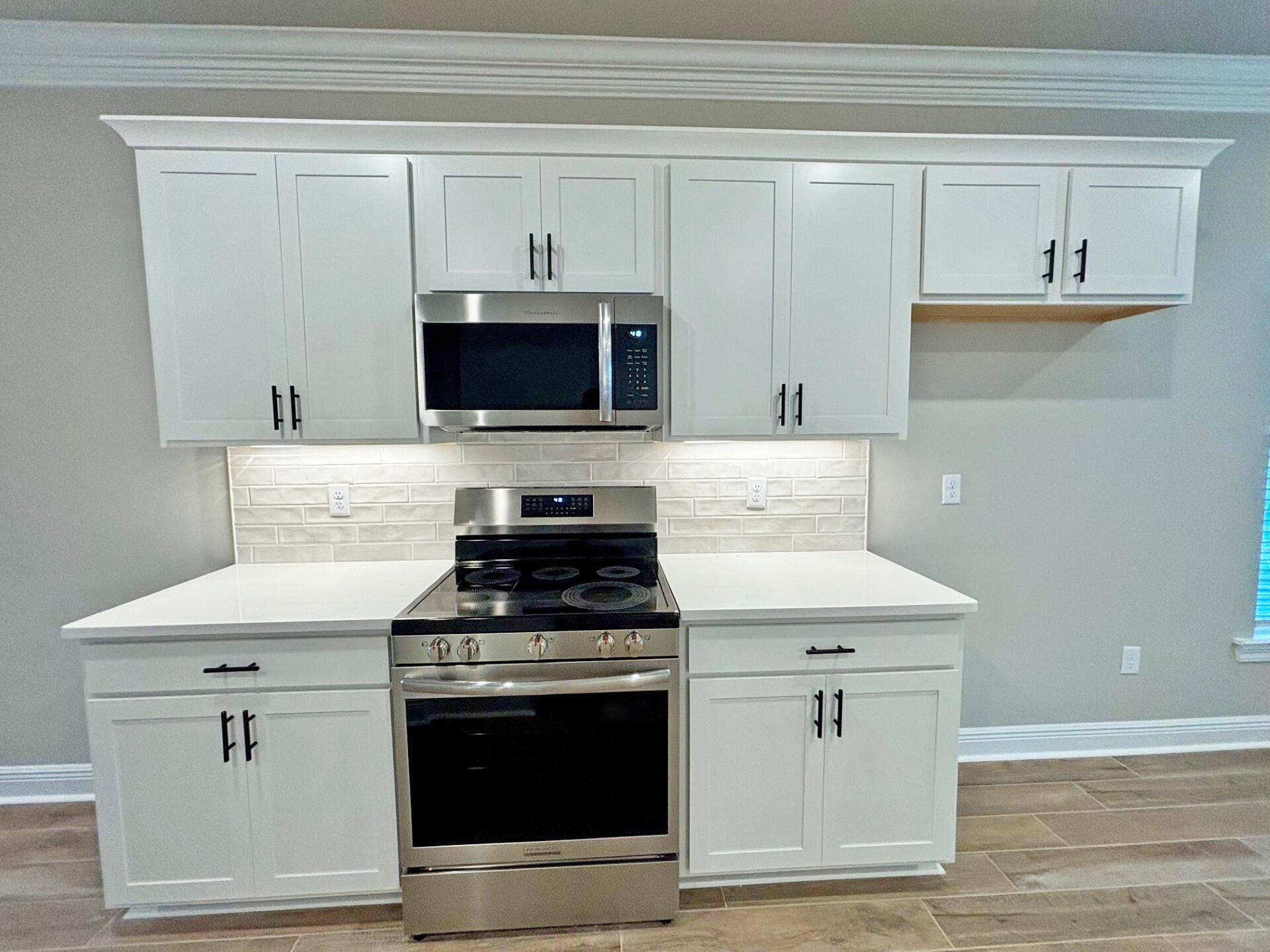 75 Natureview Way Ponce de Leon, FL 32455 - Photo 5 of 23 a kitchen with cabinets stainless steel appliances and wooden floor