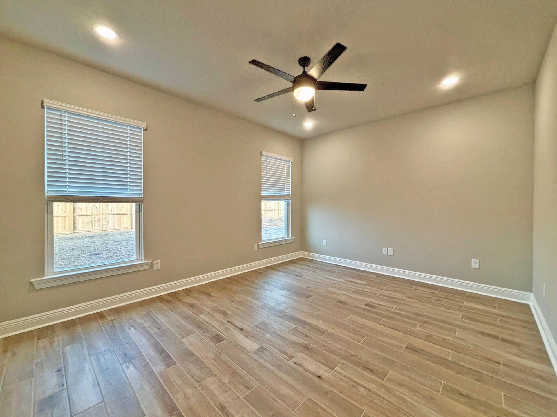 75 Natureview Way Ponce de Leon, FL 32455 - Photo 9 of 23 an empty room with wooden floor fan and windows