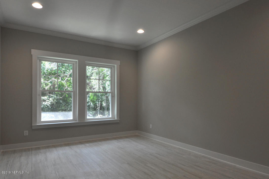 448 Ridgeway Road St. Augustine Beach, FL 32080 - Photo 17 of 23 an empty room with wooden floor and windows