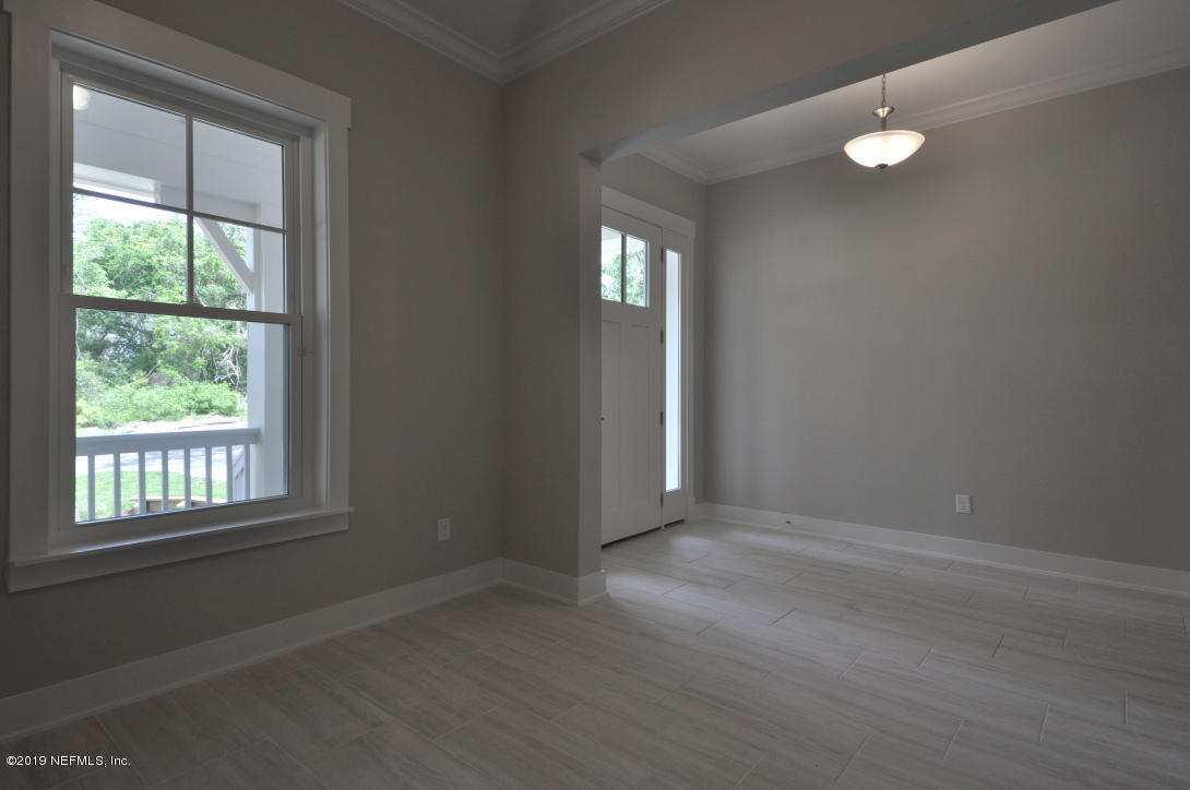448 Ridgeway Road St. Augustine Beach, FL 32080 - Photo 4 of 23 an empty room with wooden floor and windows