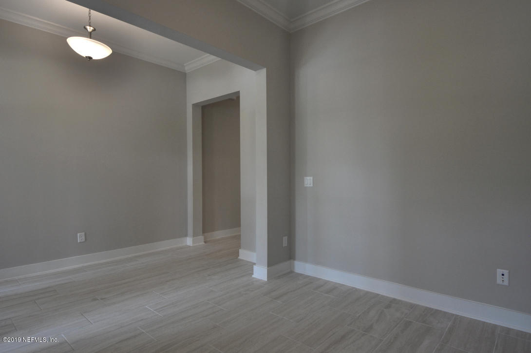 448 Ridgeway Road St. Augustine Beach, FL 32080 - Photo 5 of 23 a view of an empty room with wooden floor and a window