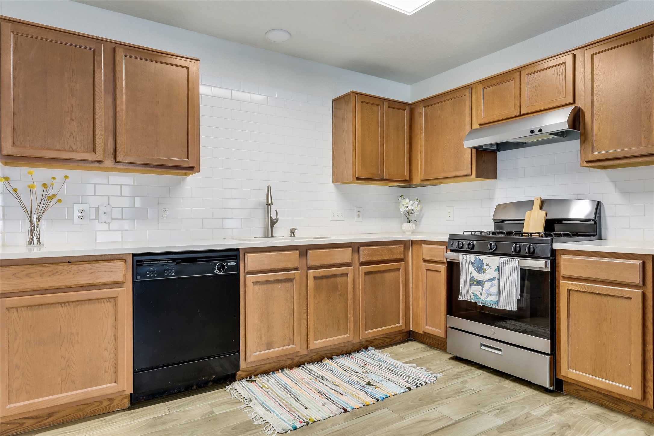 4510 Secure Lane Austin, TX 78725 - Photo 9 of 24 a kitchen with stainless steel appliances granite countertop a sink stove and cabinets
