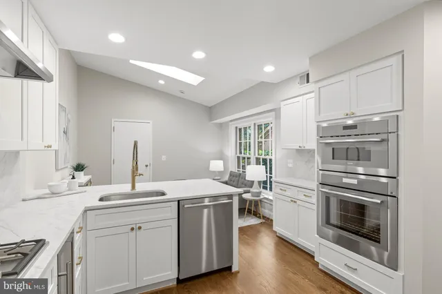 a kitchen with a sink stove and oven