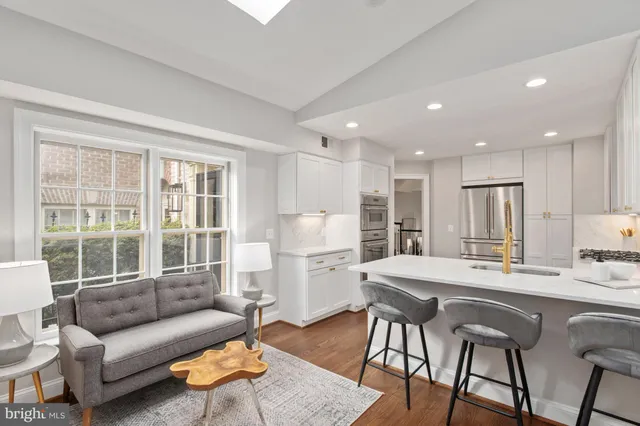 a living room with furniture and kitchen view