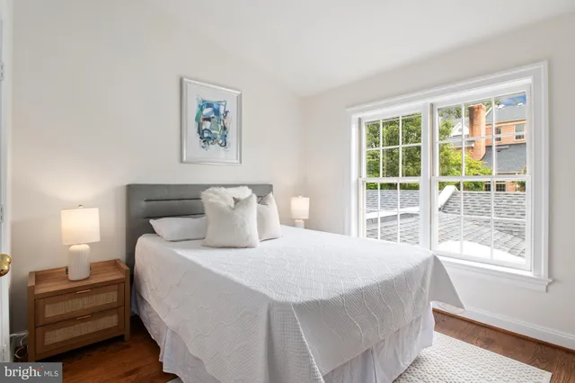 a bedroom with a bed and a large window