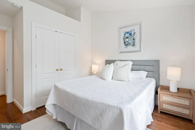 a bedroom with a bed and a painting on the wall