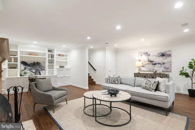 a living room with furniture kitchen view and a table