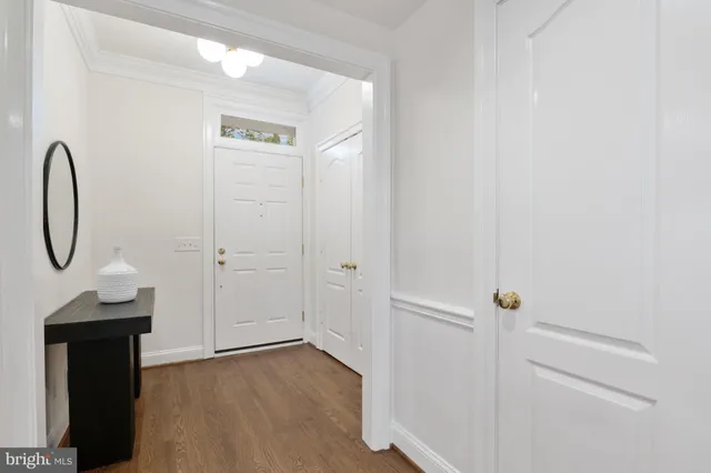 a view of a livingroom with wooden floor and a staircase