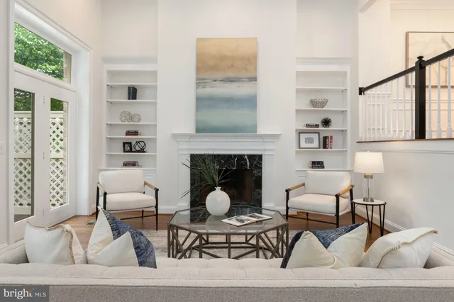 a living room with furniture a rug and a fireplace