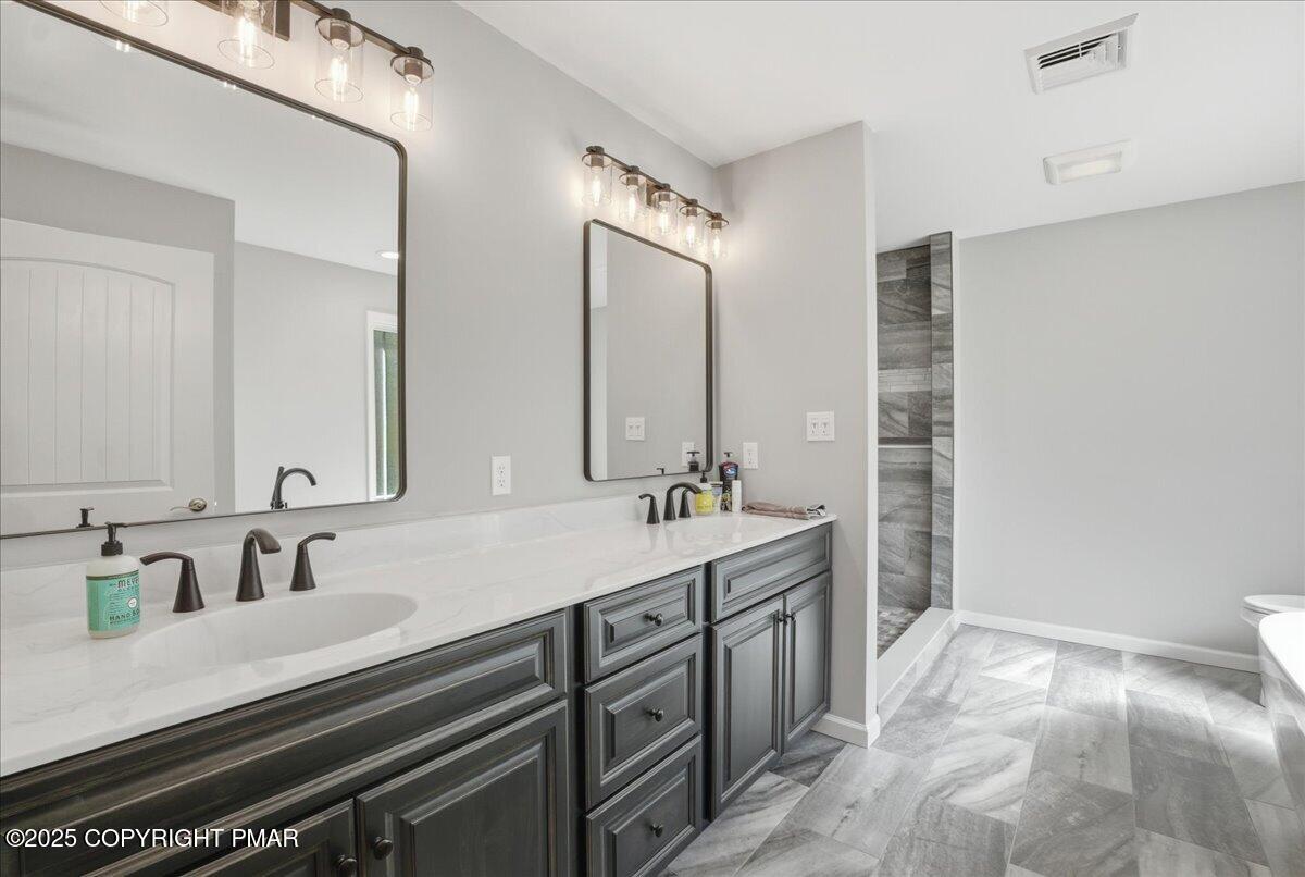 154 Sterner Run Road Kunkletown, PA 18058 - Photo 28 of 104 a bathroom with a double vanity sink and a mirror