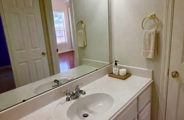 a bathroom with a sink and a mirror
