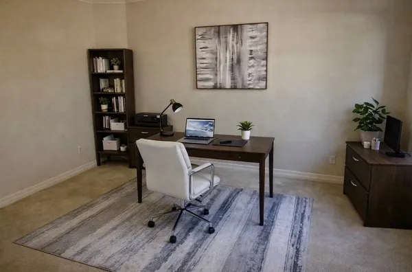 a view of a workspace with furniture and wooden floor