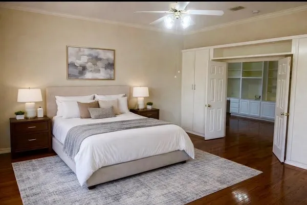 a bedroom with a bed and wooden floor