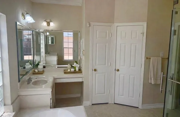 a bathroom with a double vanity sink and mirror