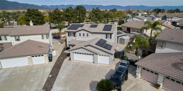 an aerial view of a house with a yard