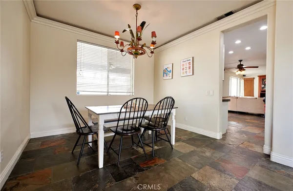 a view of a dining room with furniture and a chandelier