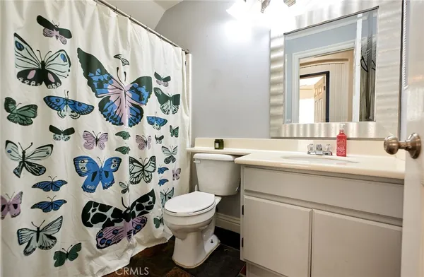 a bathroom with a sink and mirror with toilet