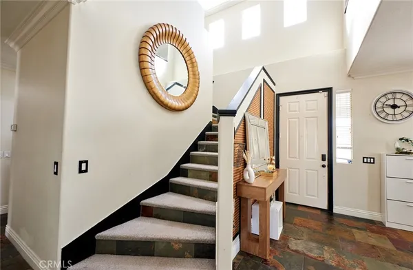 a view of a hallway with wooden floor and workspace