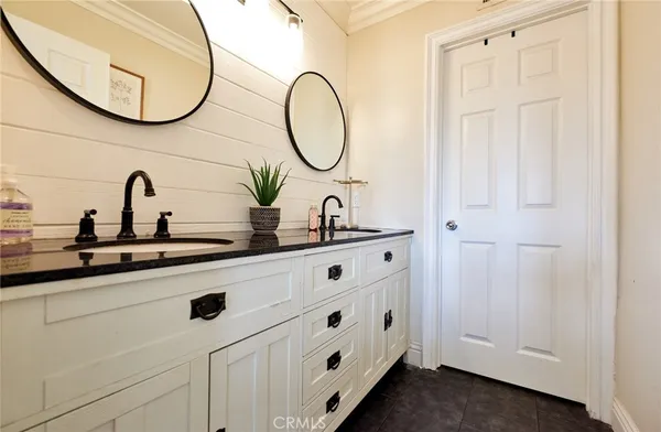 a bathroom with a double vanity sink and a mirror