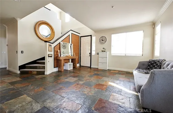 a view of a livingroom with furniture and entryway