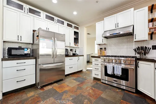 a kitchen with a stove sink and cabinets