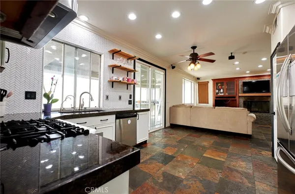 a large kitchen with granite countertop a sink and a stove