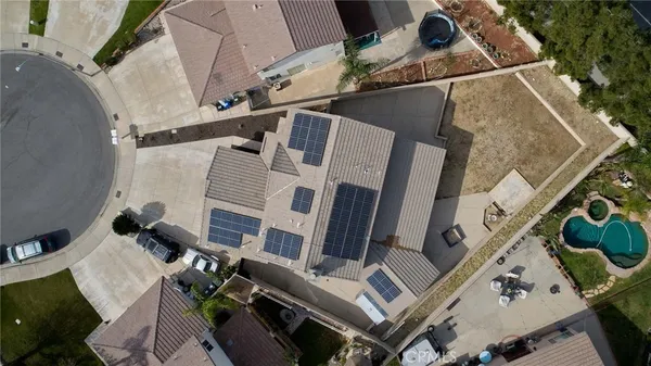 an aerial view of a house with a yard