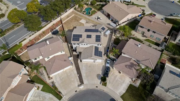 an aerial view of a house with outdoor space and a parking space