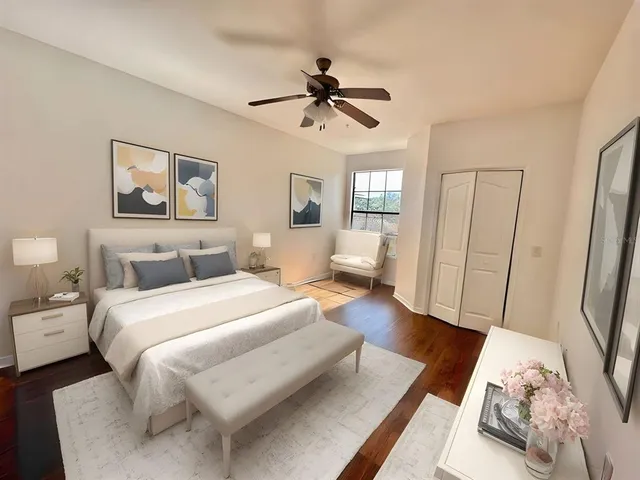 a spacious bedroom with a bed and a large mirror