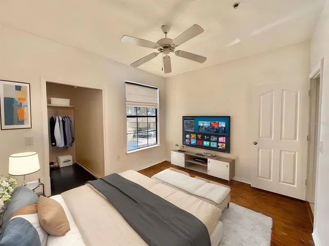 a bedroom with a bed and a flat screen tv