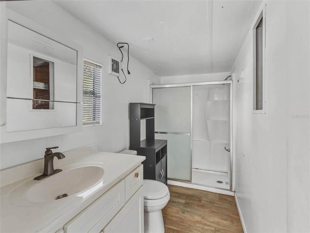 7275 Knowles Road Polk City, FL 33868 - Photo 12 of 39 a bathroom with a sink toilet and shower