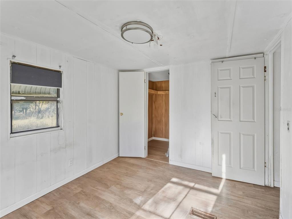7275 Knowles Road Polk City, FL 33868 - Photo 19 of 39 a view of an empty room with wooden floor