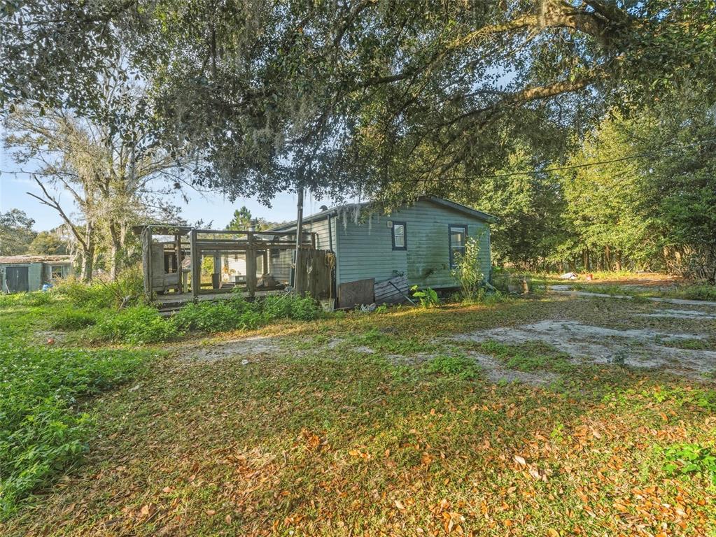 7275 Knowles Road Polk City, FL 33868 - Photo 2 of 39 a view of a house with yard and a garden