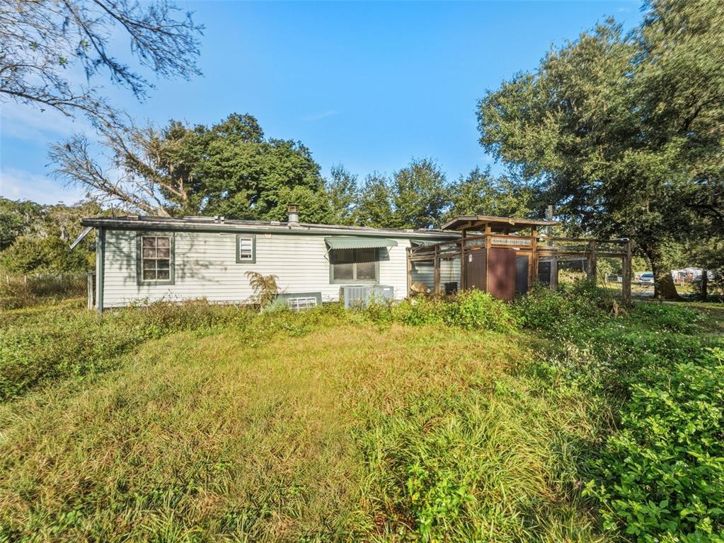 7275 Knowles Road Polk City, FL 33868 - Photo 26 of 39 a view of a house with a yard