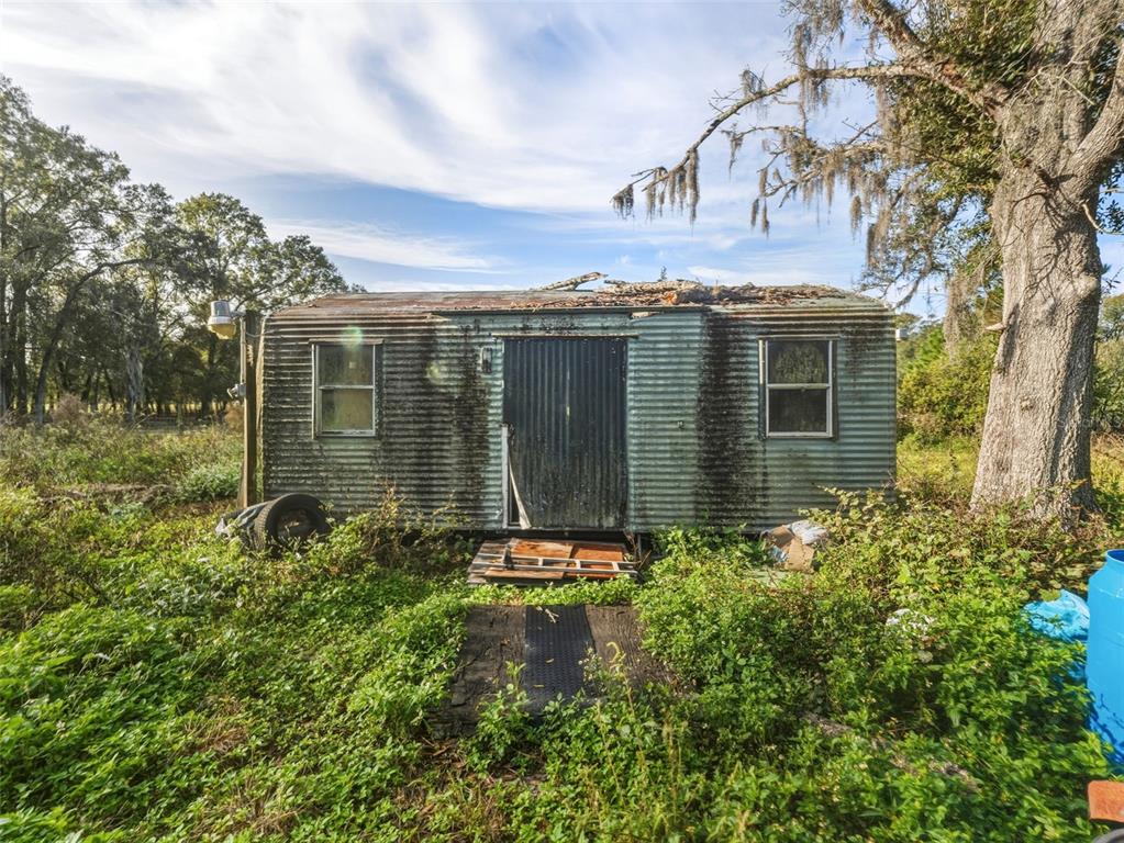 7275 Knowles Road Polk City, FL 33868 - Photo 27 of 39 a view of a house with a garden