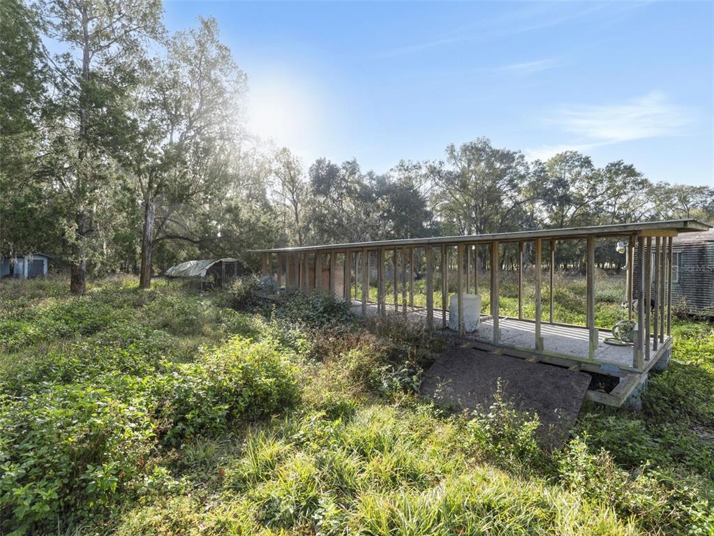 7275 Knowles Road Polk City, FL 33868 - Photo 28 of 39 a view of a lake with a house in the background