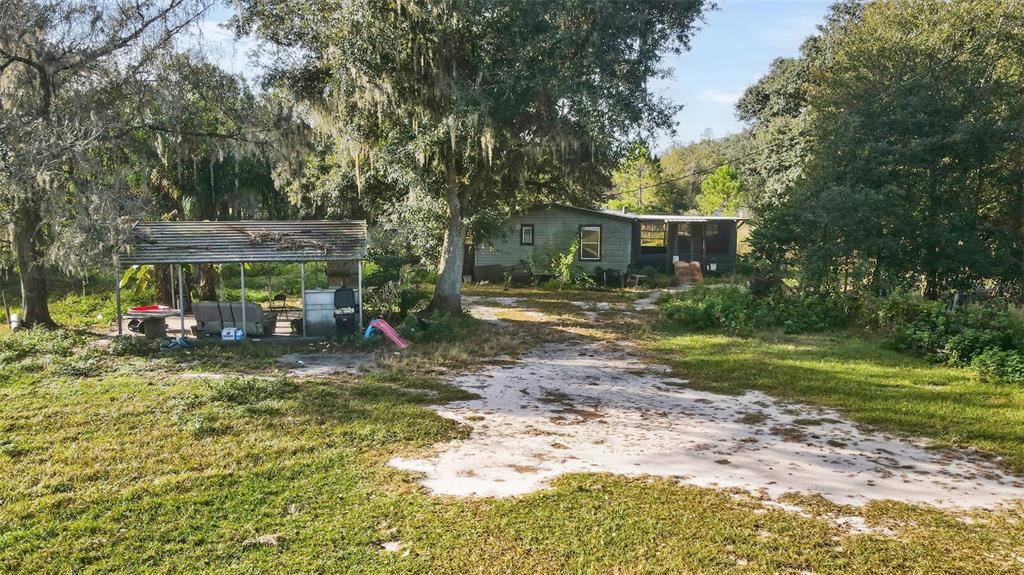 7275 Knowles Road Polk City, FL 33868 - Photo 30 of 39 a view of a house with a yard