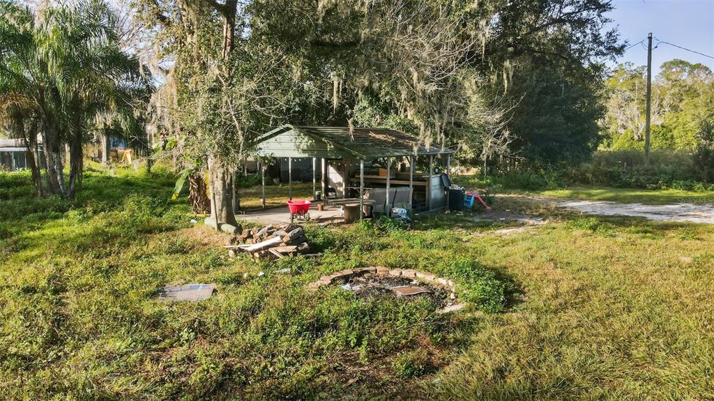 7275 Knowles Road Polk City, FL 33868 - Photo 31 of 39 a view of a garden with a tree