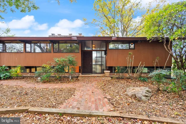 a front view of a building with a garden