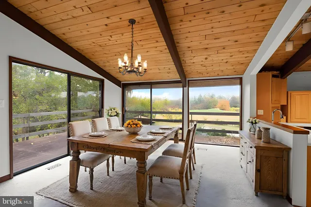 a bedroom with a large bed and large windows